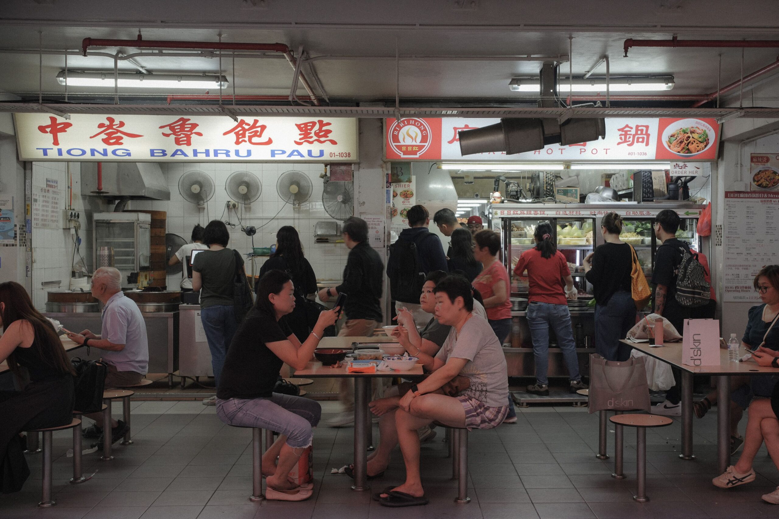 Customers dining at a busy Tiong Bahru hawker centre in Singapore