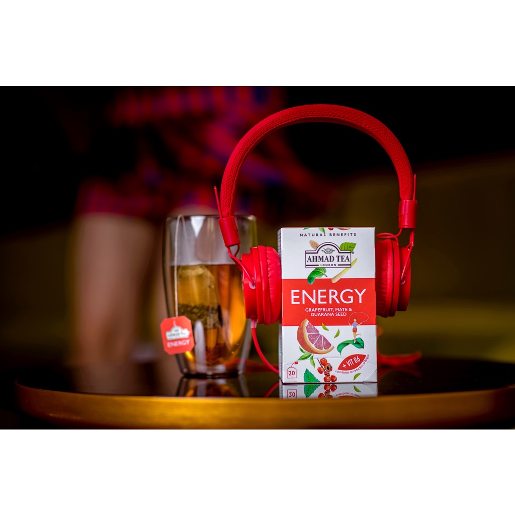 Ahmad Tea Energy infusion with a glass and red headphones